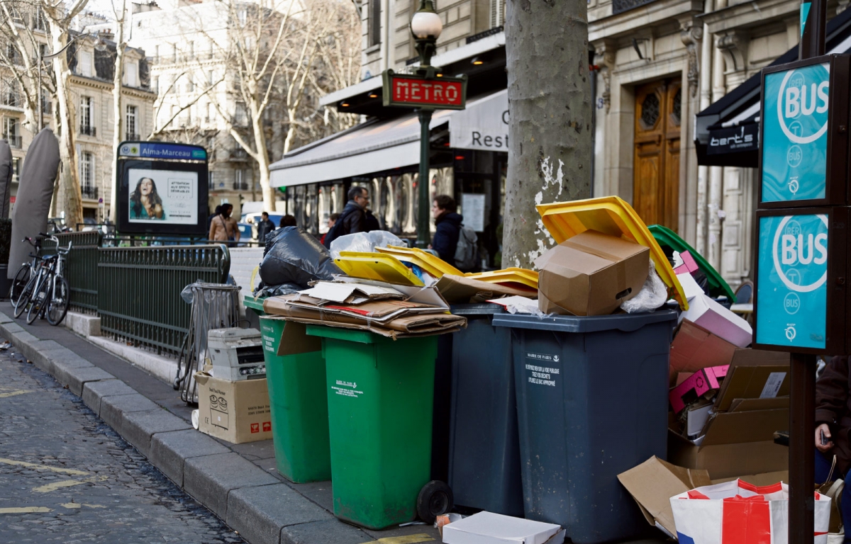 Overflowing trash bins are seen near a metro station as waste incineration plants go on strike in Paris, France