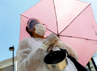 Eine Frau mit Schirm demonstriert in São Paulo (Brasilien) gegen Hunger in der Covid-19-Pandemie, 26. März
